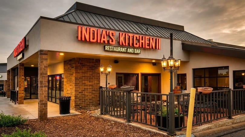 Exterior of India's Kitchen restaurant and bar with outdoor seating under a cloudy sky.